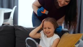mother-taking-care-child-with-head-lices_23-2149480459